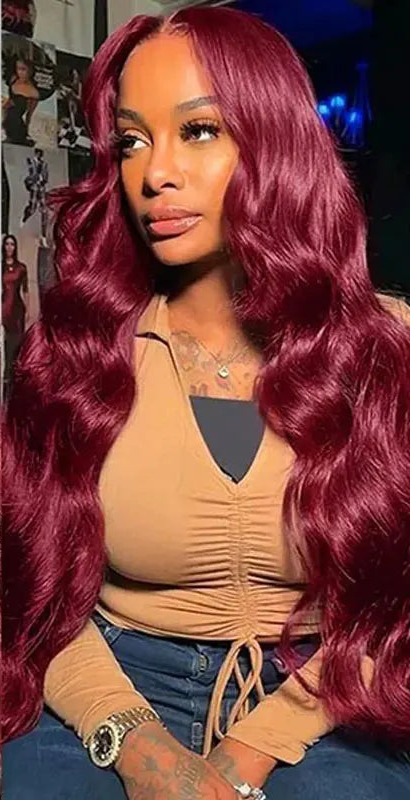 Model wearing Wine Flow 99J Body Wave Wig with HD lace frontal, styled in soft waves and deep burgundy tone.