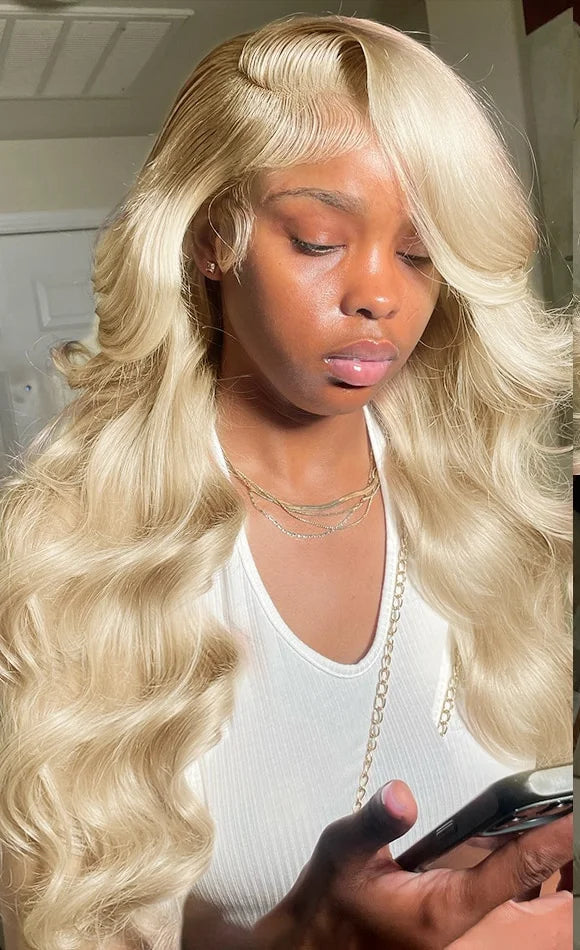 Model wearing 613 Blonde Body Wave Wig with 13x6 HD Lace, styled in soft waves and luminous color. Pre-plucked hairline with baby hair and 280% density.