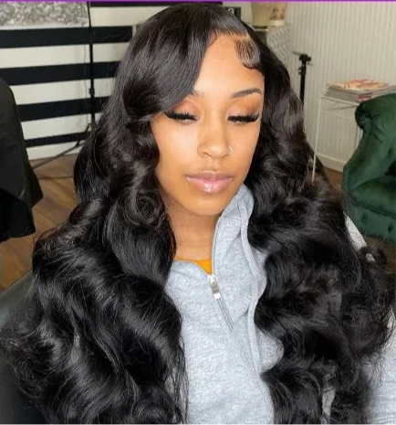 Model wearing Body Wave Wig HD Lace 13x6 – Natural Black – Laid Flow, styled in soft waves with seamless lace melt.