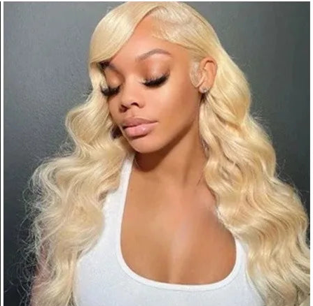 Model wearing Wig Body Wave HD Lace 13x6 – 613 Blonde – Current Theory, styled with transparent lace and soft glam texture.
